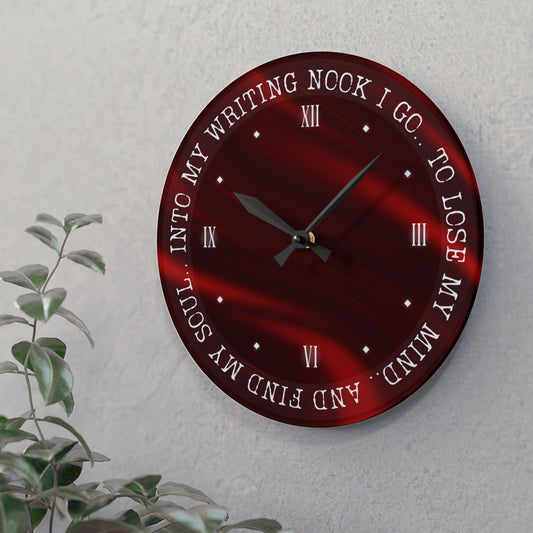 a red wall clock, which says "into my writing nook I go, to lose my mind and find my soul" hanging on a white wall, it was a gift to a dark romance author and hangs as book inspired decor in her home office